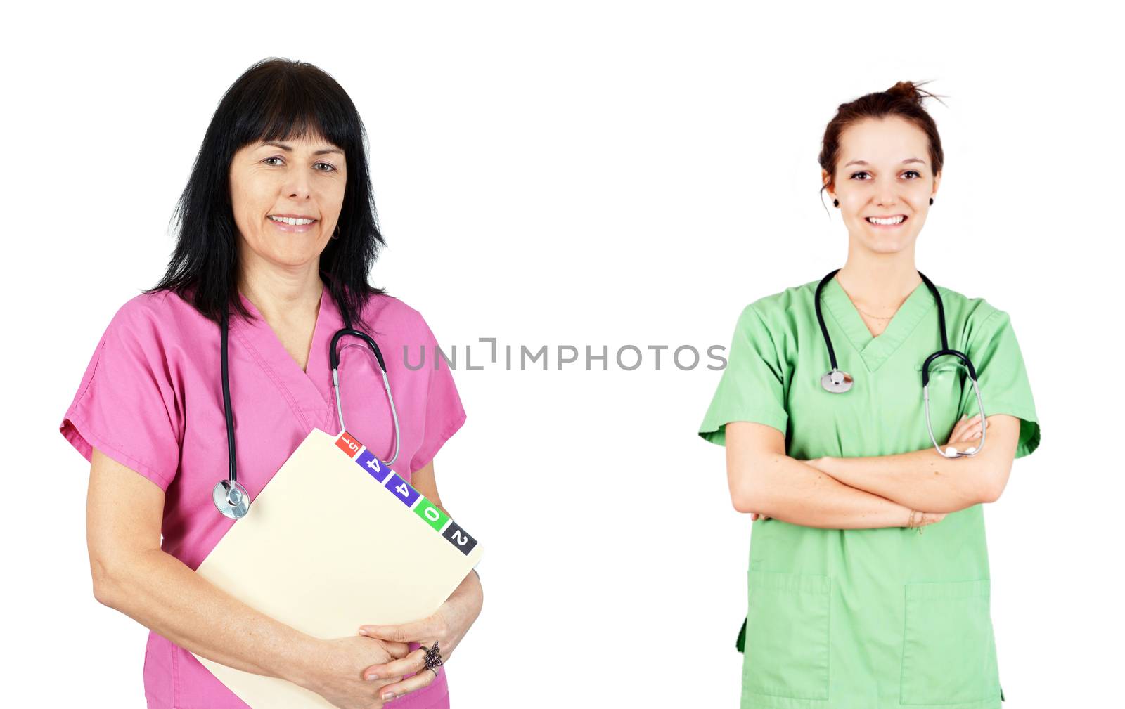 Friendly female doctors or nurses in pink and green scrubs isolated on white.