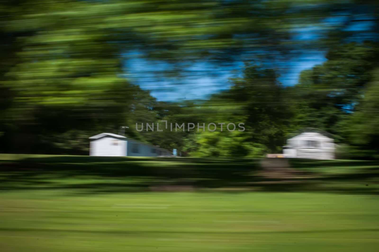 blurred out country landscape while driving