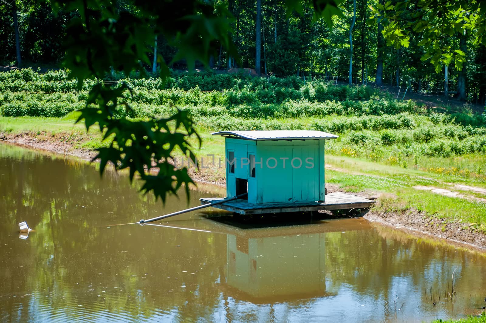 farm building water pump on lake