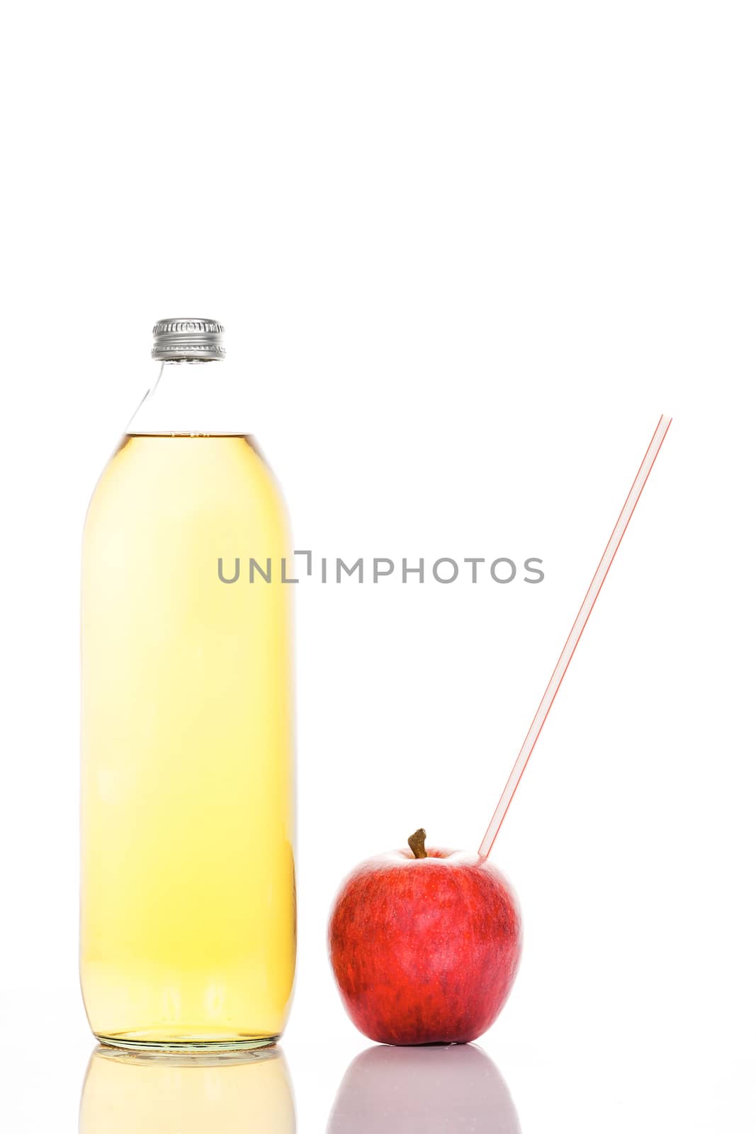 Apple juice in a glass bottle and apple with straw