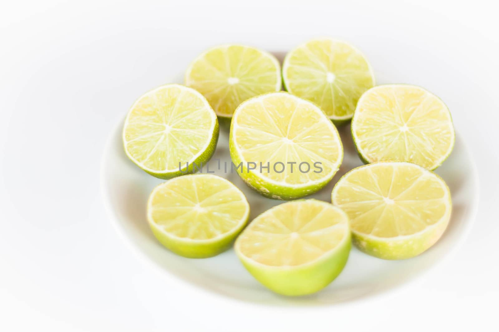 Fresh lime slice on white ceramic dish