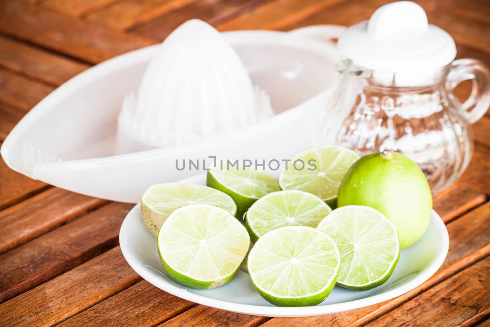 Fresh lime with glass jar and hand squash tool by punsayaporn