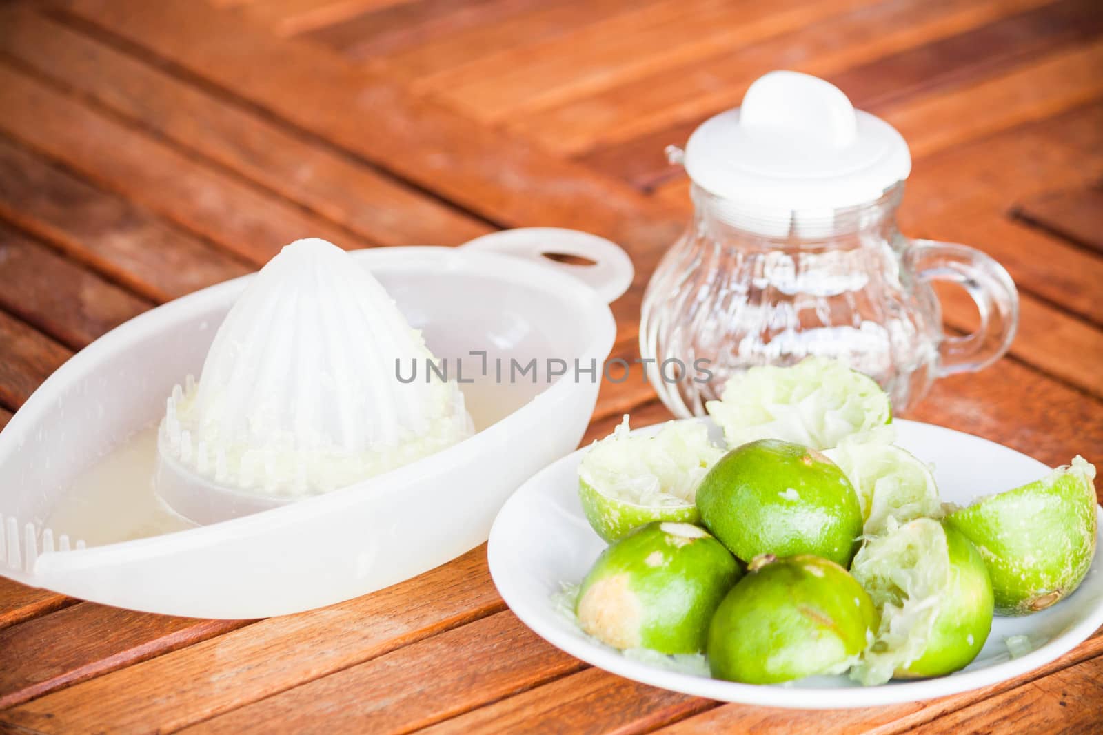 After squashed fresh citrus lime on wood table by punsayaporn