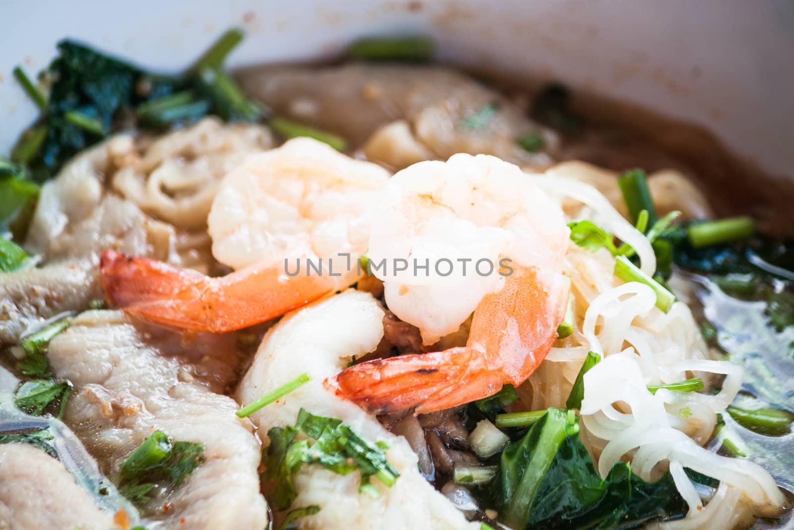 Double shrimps topped on thai style spicy noodles soup