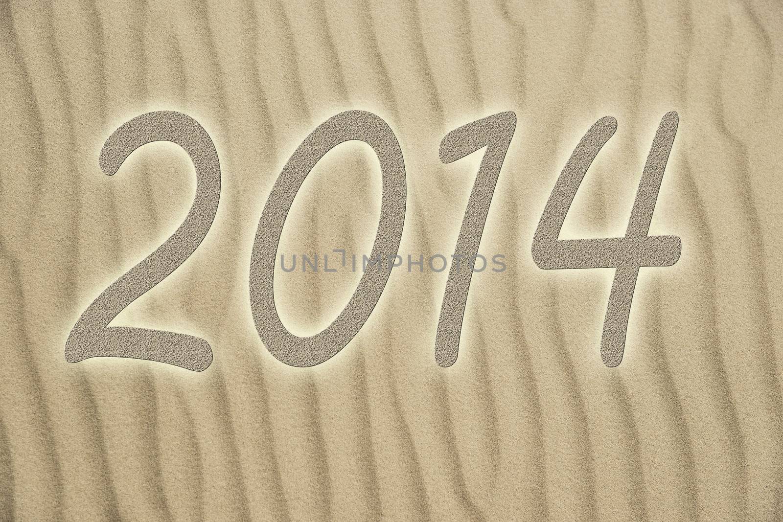 Picture of golden sand with small waves and letters 2014