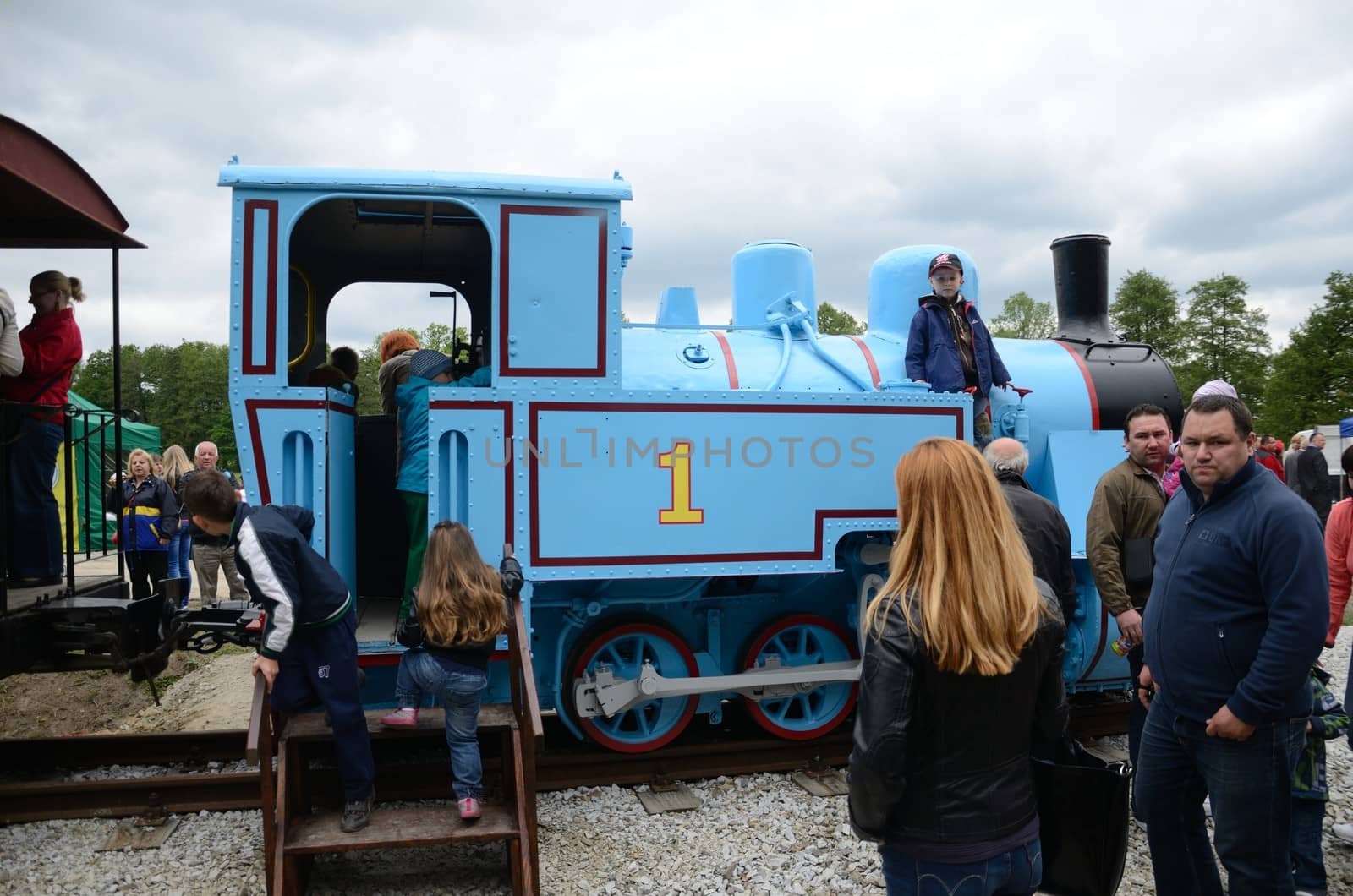 KROSNICE, DOLNY SLASK, POLAND - MAY 25: Restored narrow gauge railroad in Krosnice. Unidentified children watch locomotive on 25 May 2013 in Krosnice, Poland.