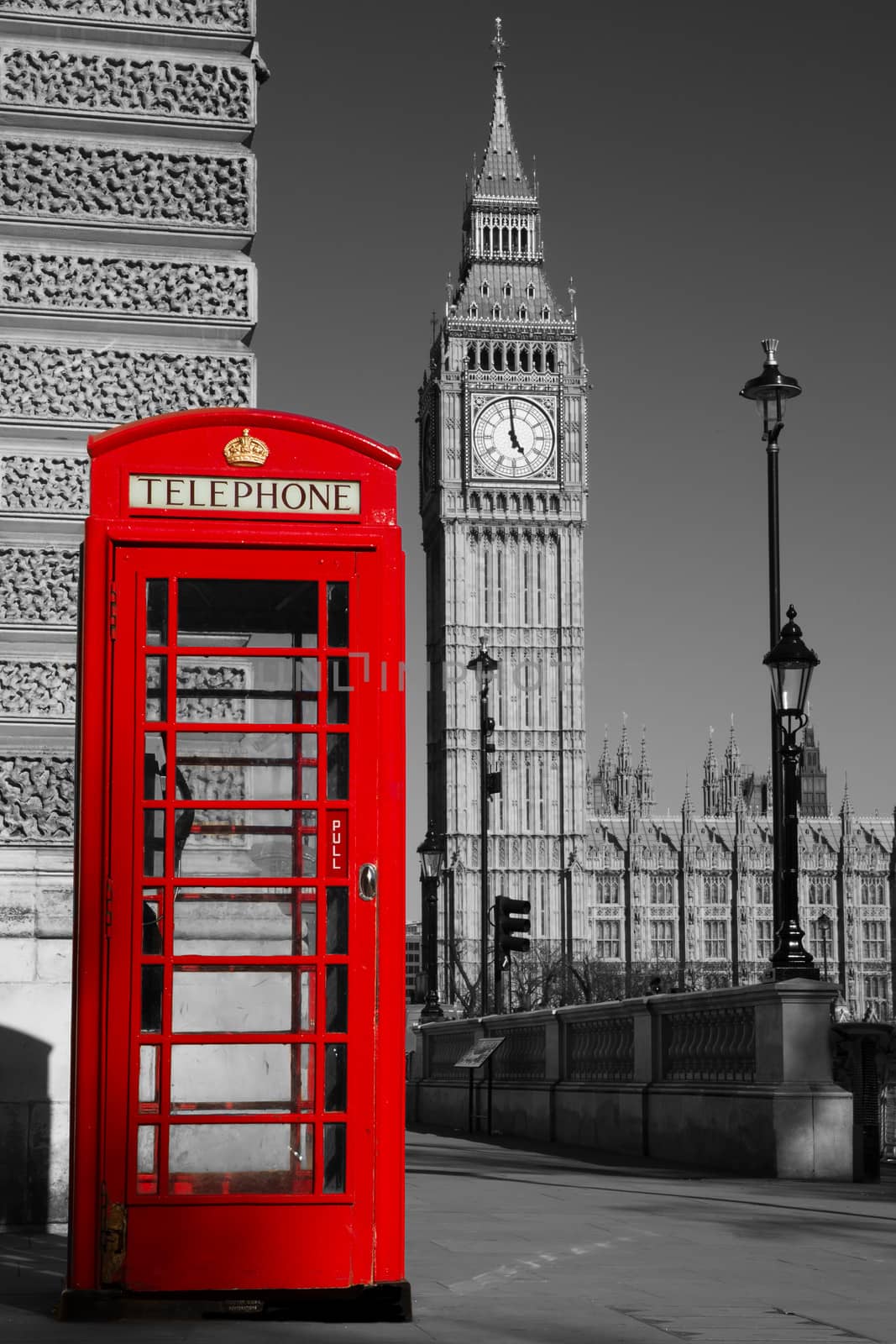 Westminster phone box in colour with the Palace of Westminster in black and white in the background.