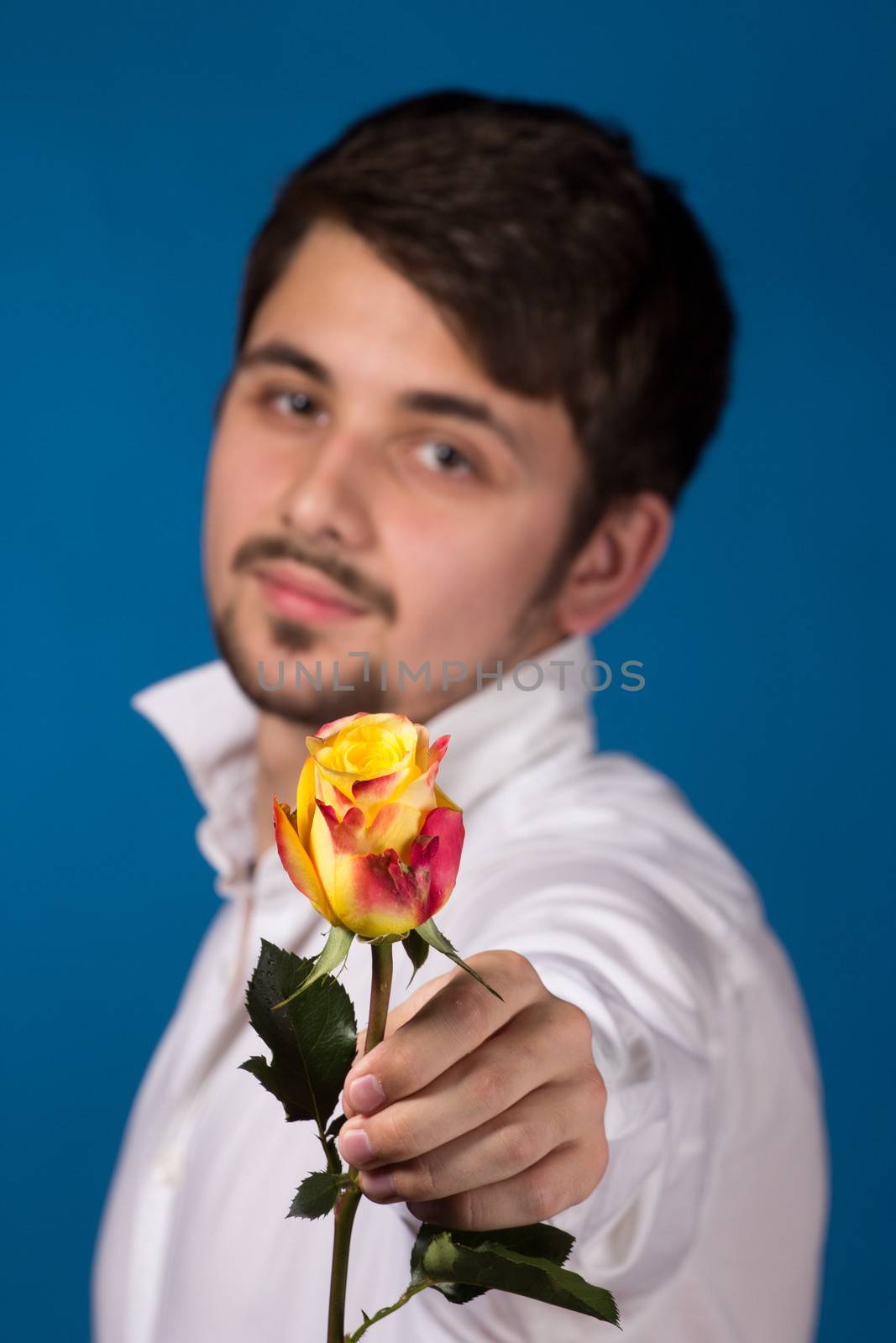 Man giving the red roses. Close up portrait. by gsdonlin