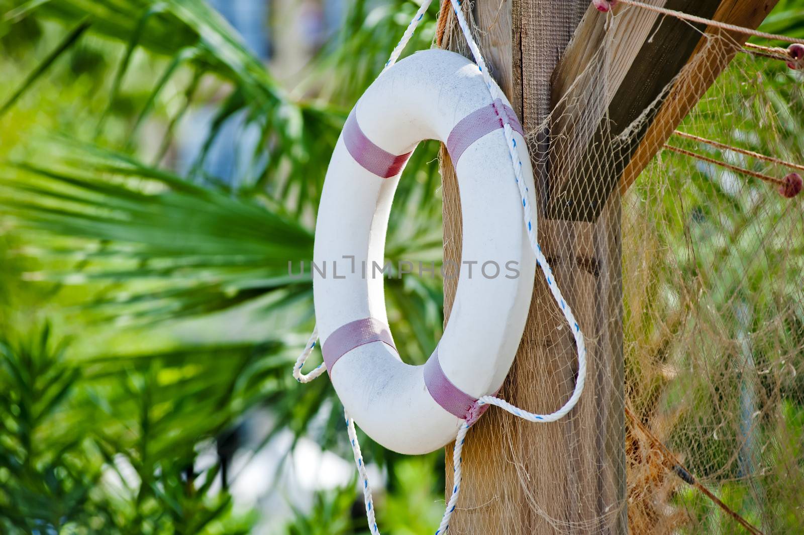 White life preserver hanging on a wooden post