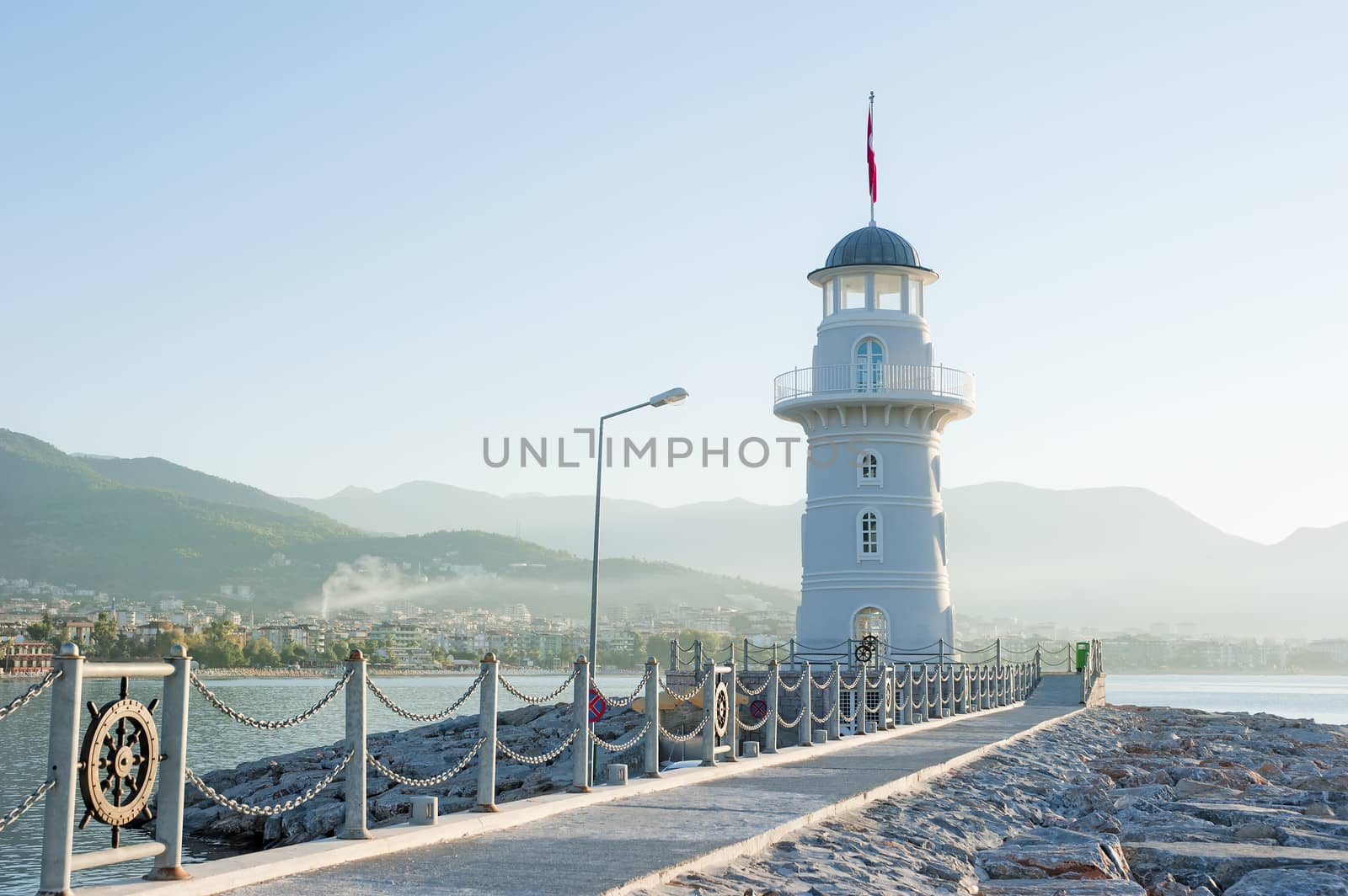 Landscape with a lighthouse in the harbor town of Alanya at dawn. by kosmsos111