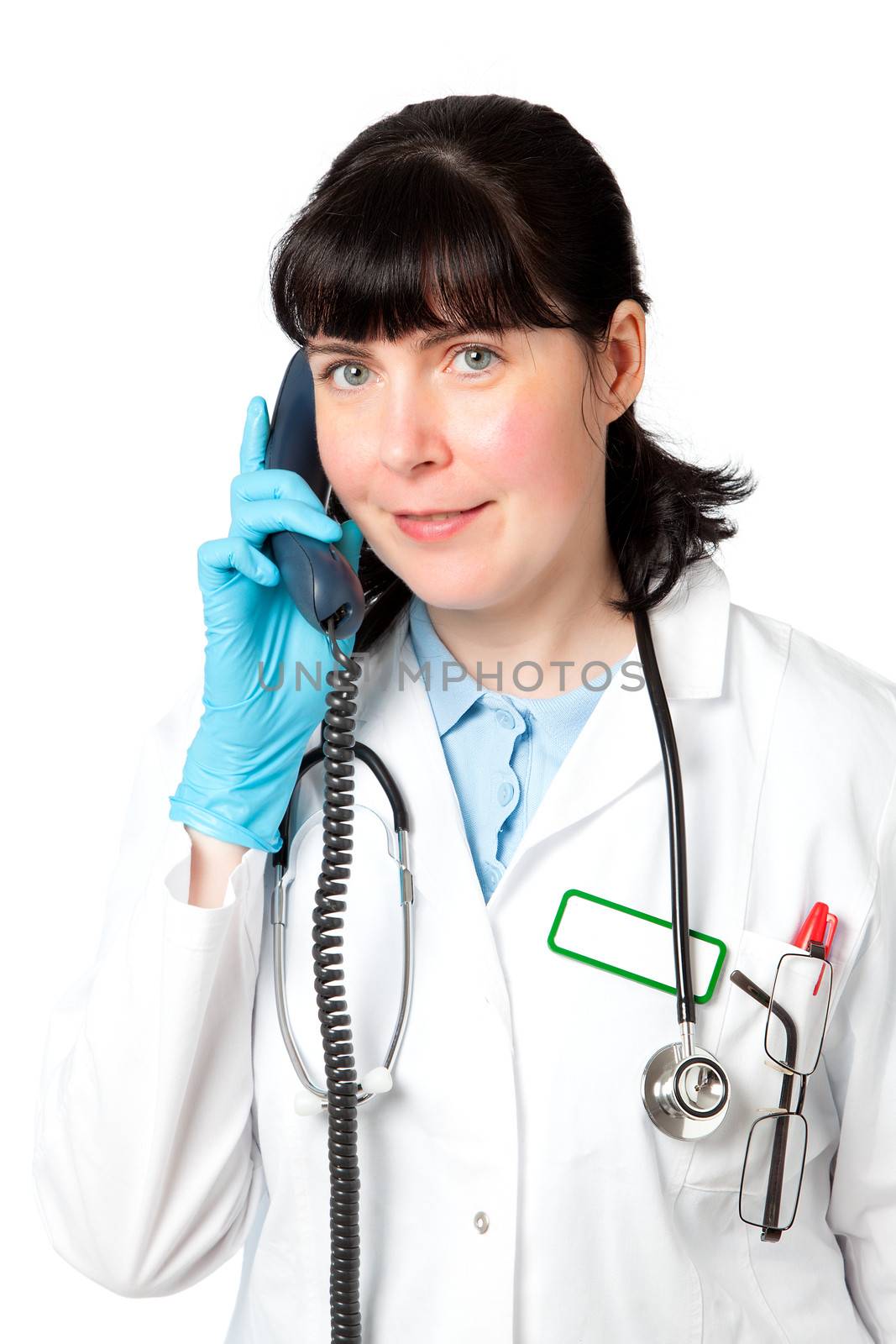 Portrait of a friendly female doctor using a telephone