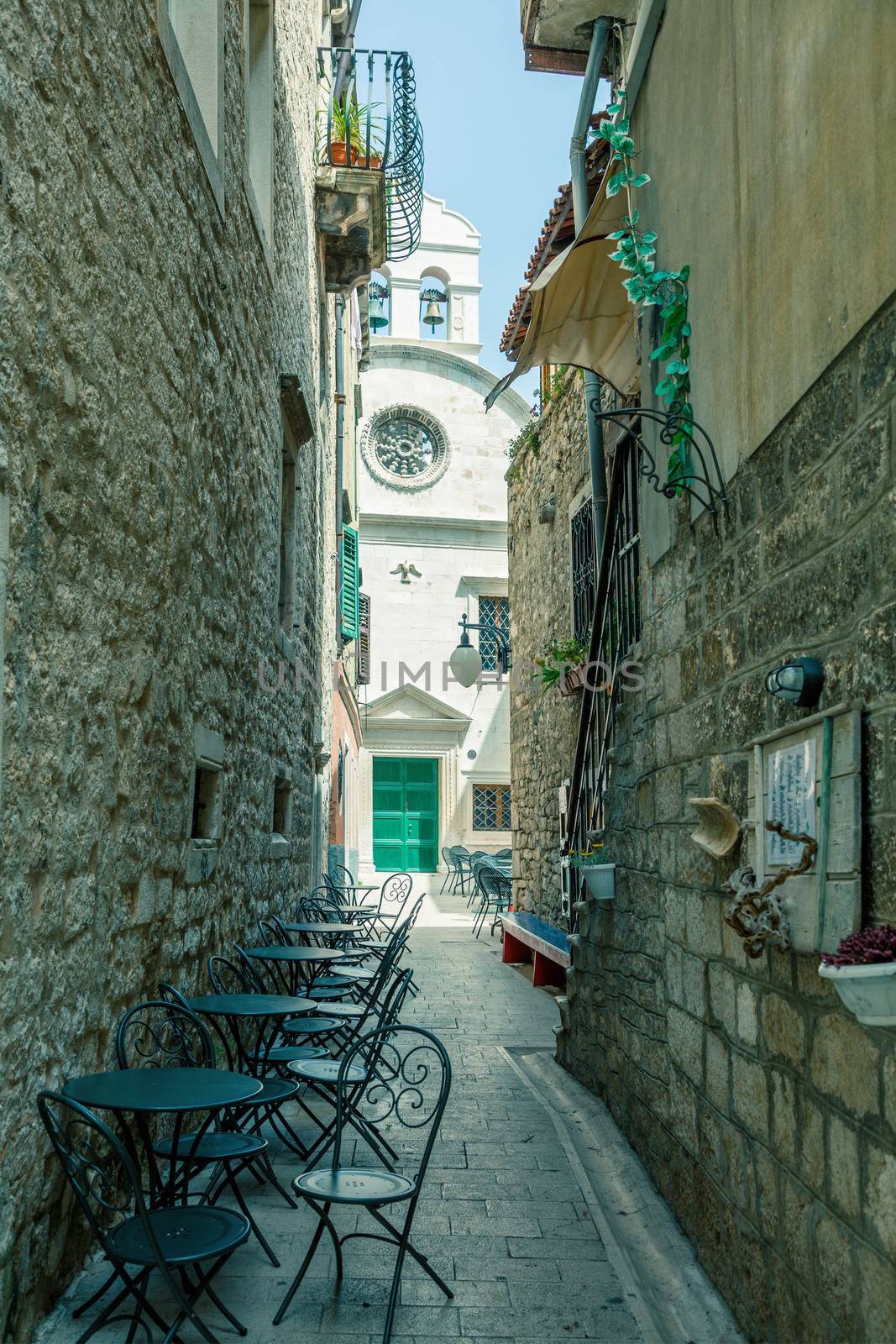 Atmospheric cafe in a narrow street in city of Zadar, Dalmatia,  by motorolka