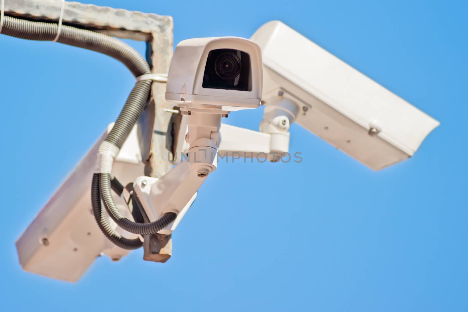 Three outdoor video surveillance camera on the bracket. by kosmsos111