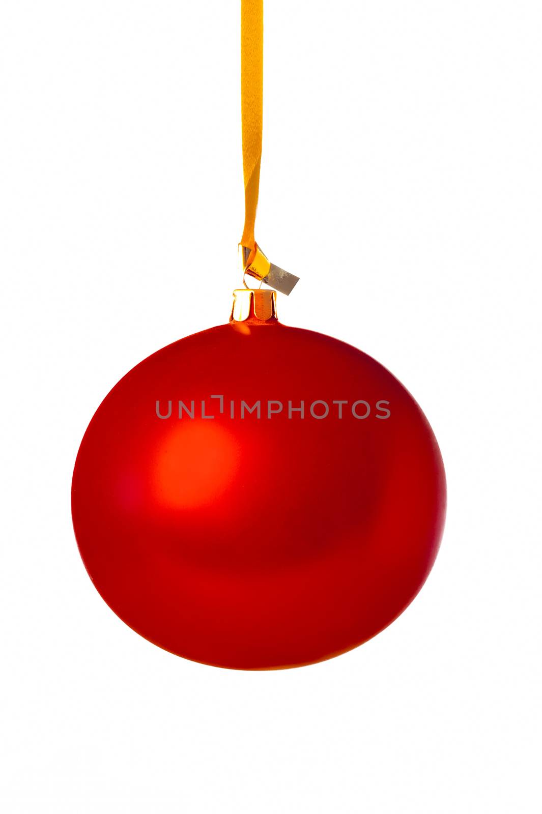 Red Christmas ball hanging on a golden ribbon