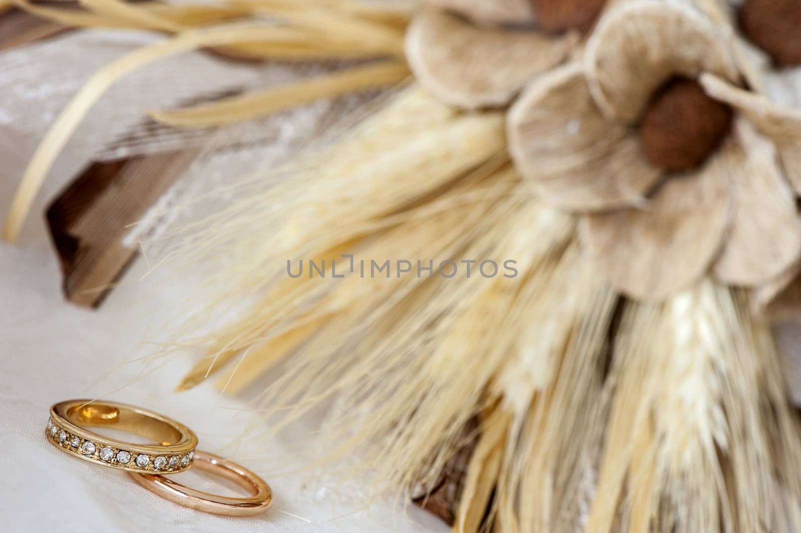 wedding favors and wedding ring on on colored background