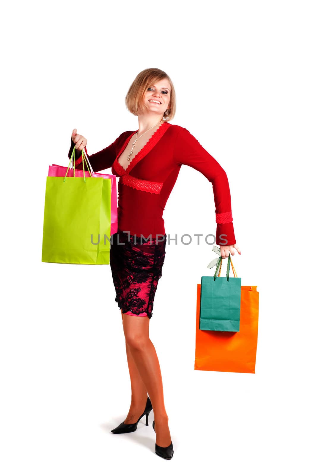 Beautiful woman with multicolored shopping bags isolated onwhite
