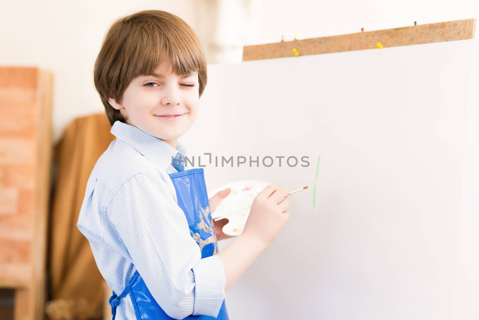 portrait of a boy standing next to his easel, a drawing lesson