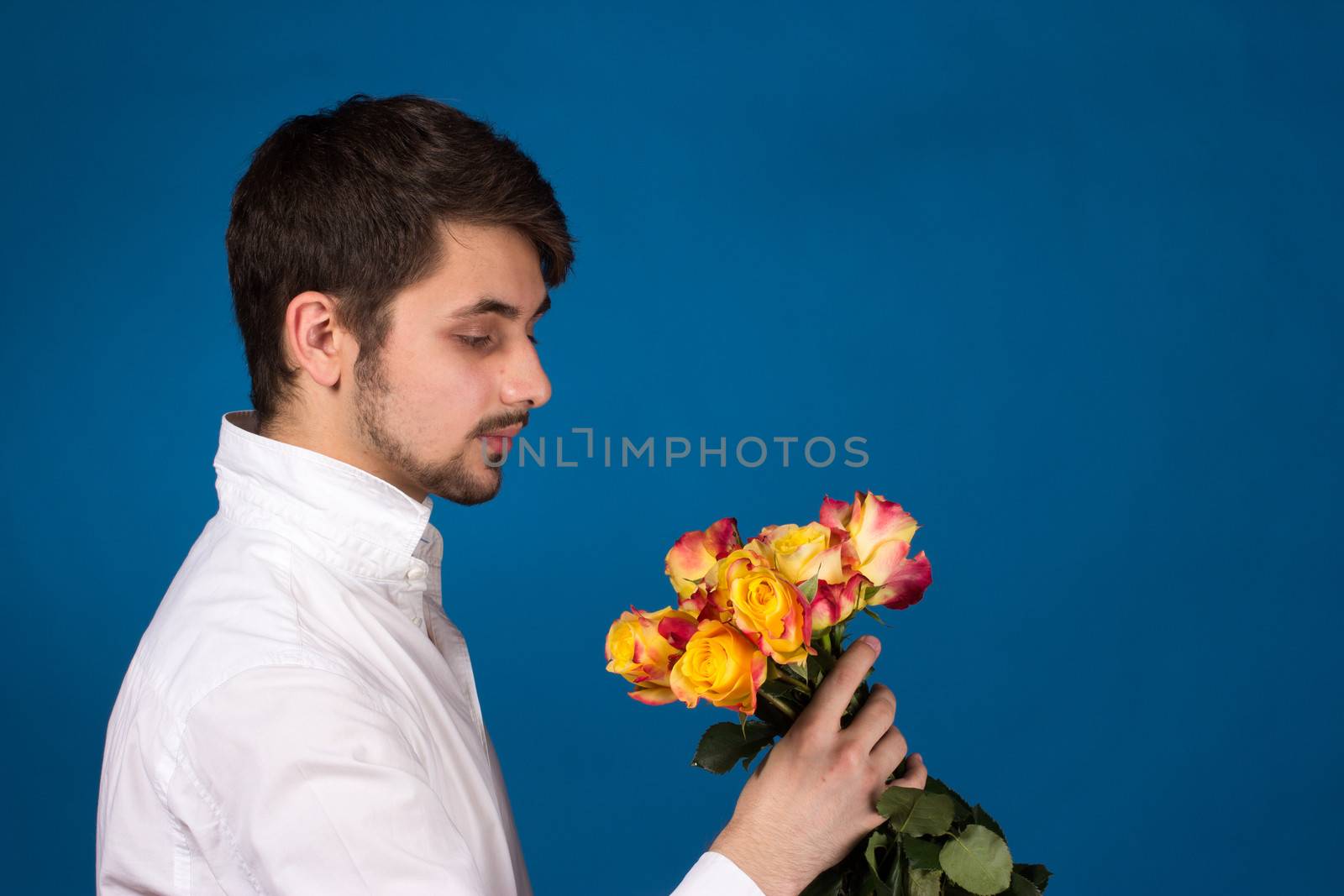 Man with bouquet of red roses by gsdonlin
