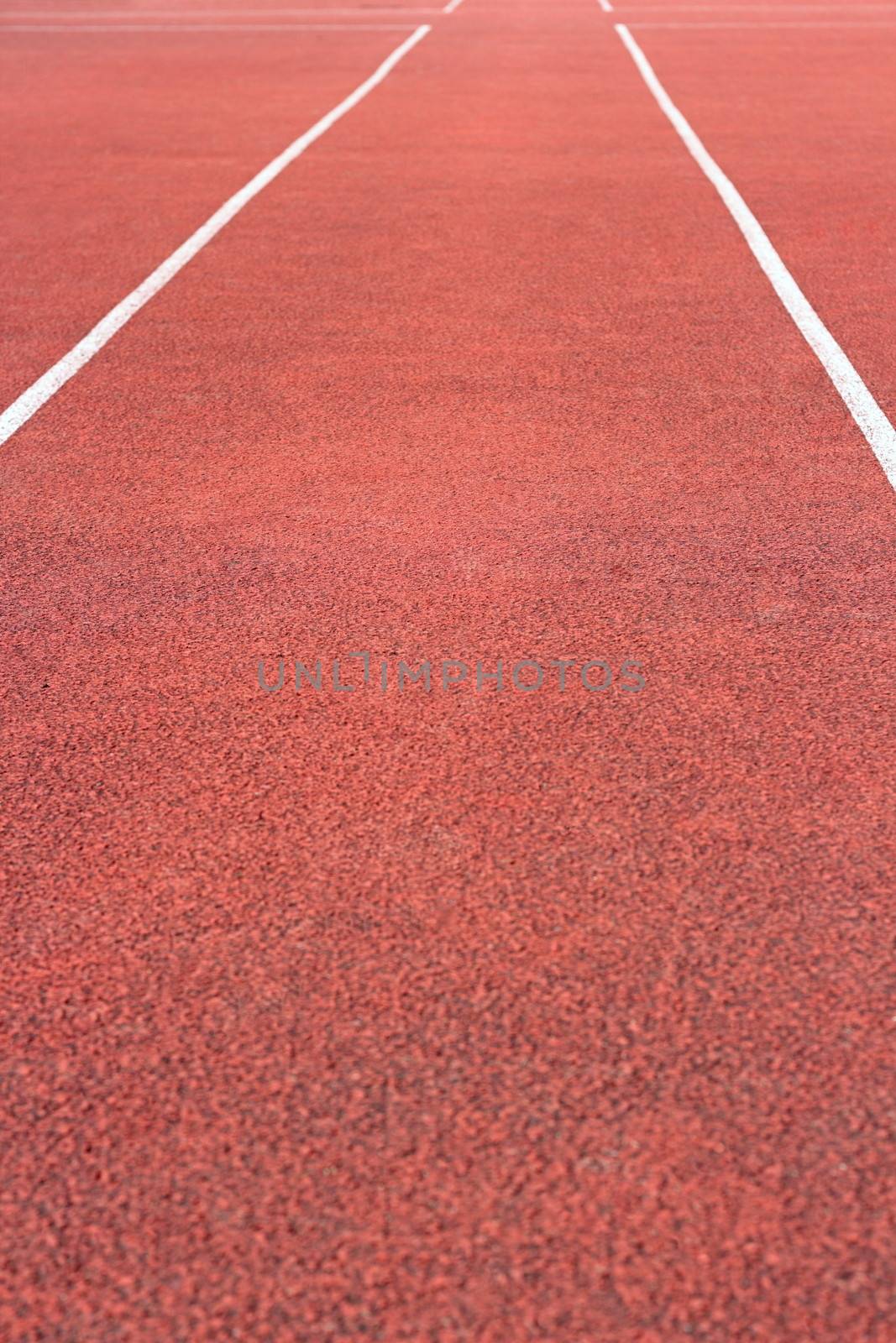 perspective of cinder running track at the sport stadium by taviphoto