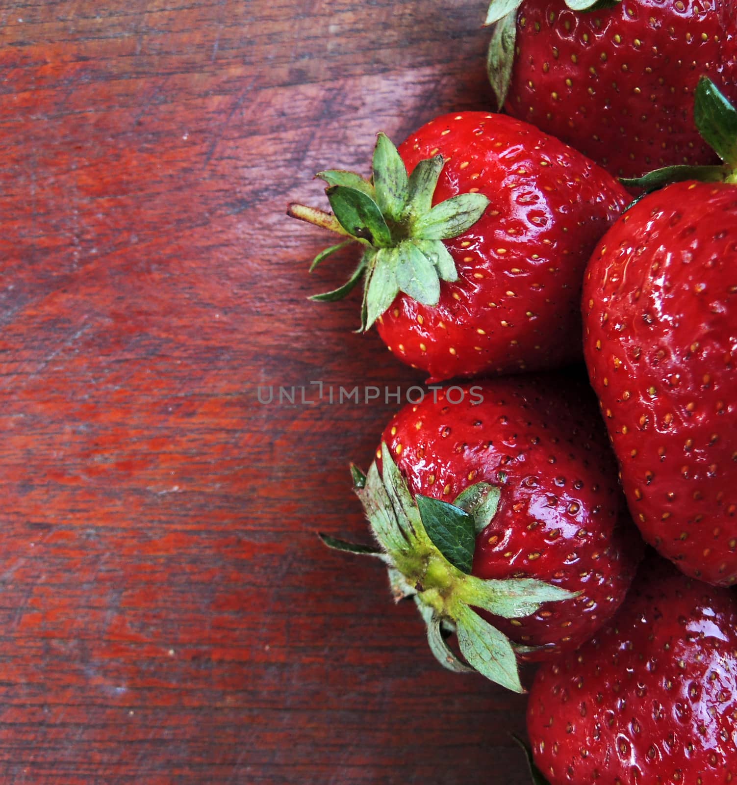 Fresh strawberries on wooden table by MalyDesigner