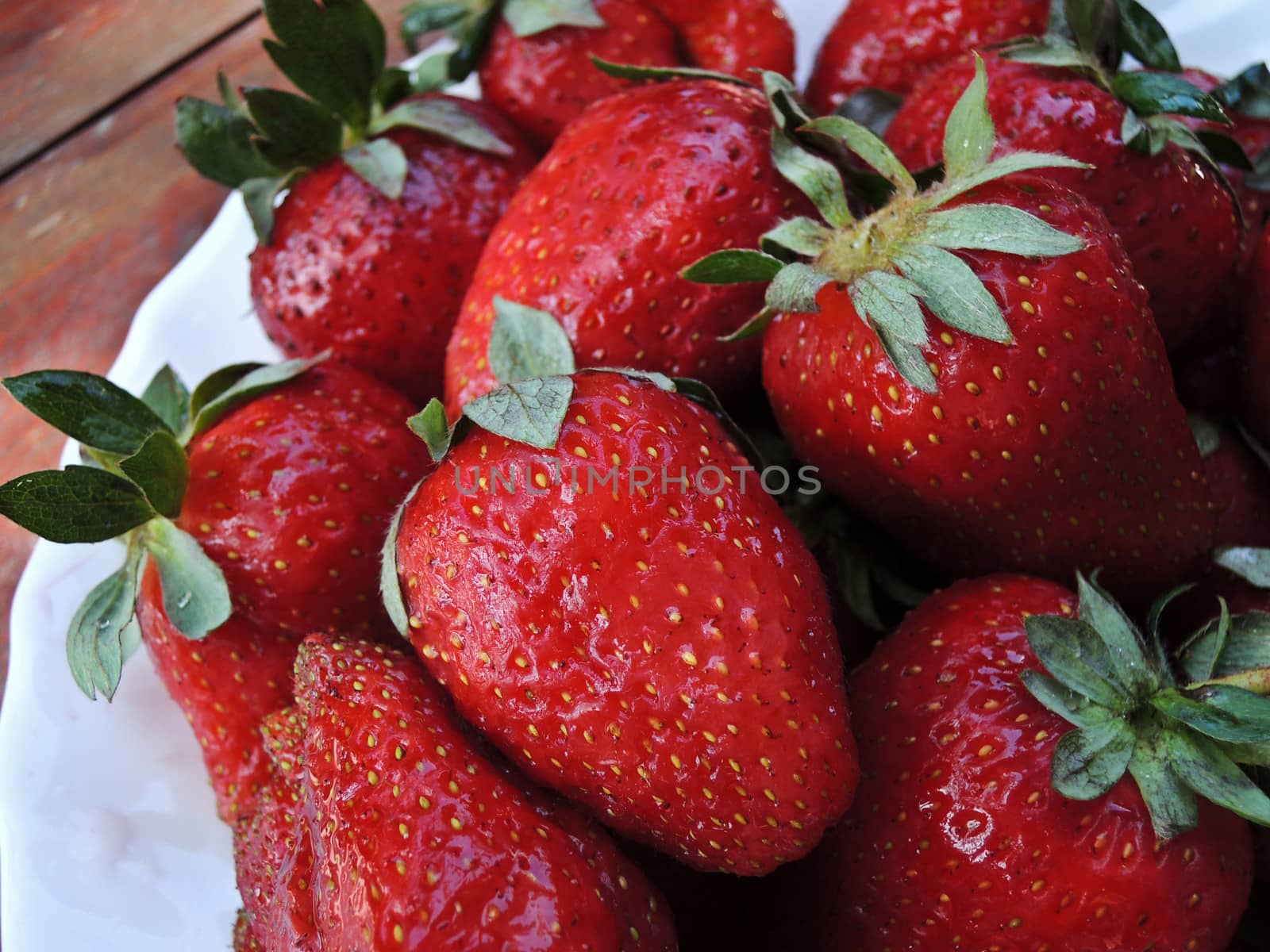 Fresh strawberries on wooden table macro