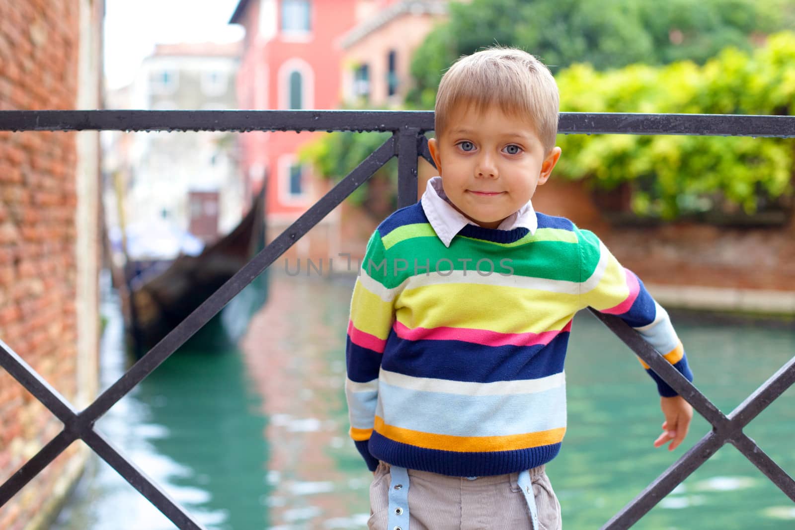 Summer venetian view and tourist boy. Venice, Italy.