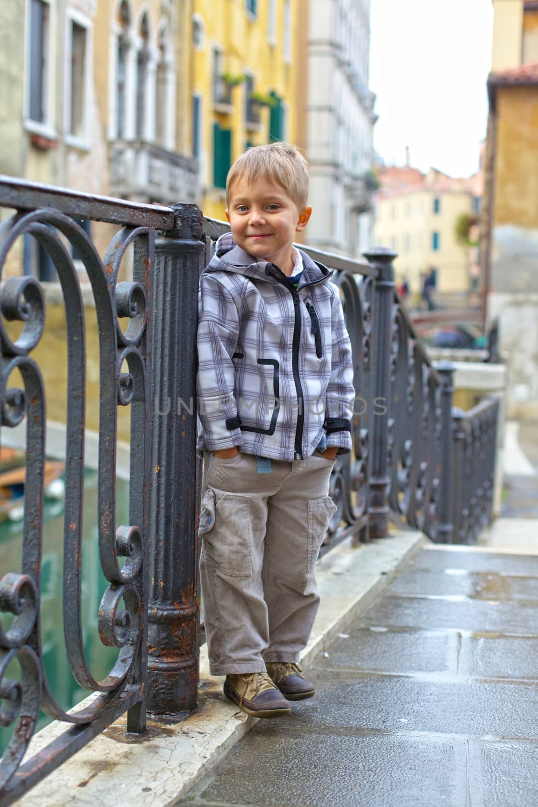 Summer venetian view and tourist boy. Venice, Italy.