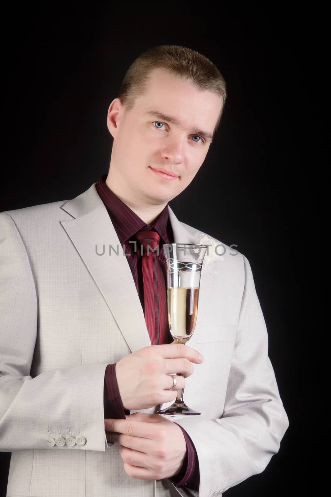 young attractive man in a suit with a glass of champagne