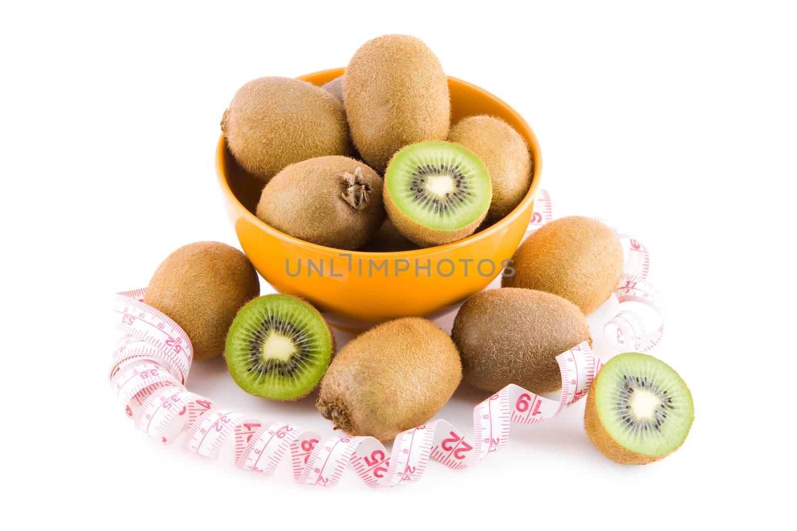 Kiwi fruits in porcelain bowl with measure tape