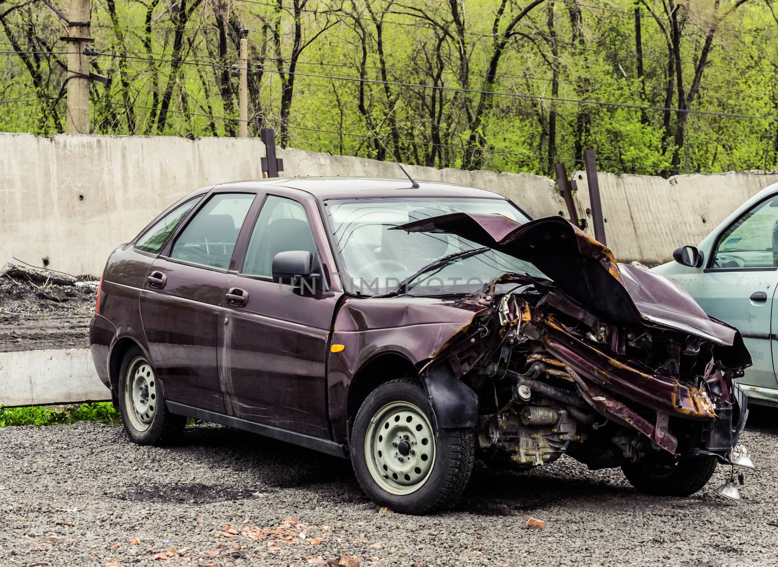 A car in a car wreckers yard after a recent crash
