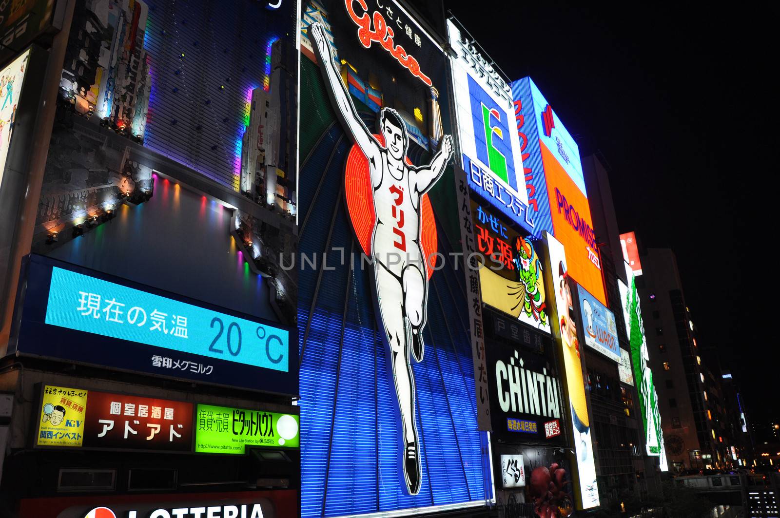 OSAKA, JAPAN - OCT 23: The Glico Man Running billboard and other neon displays on October 23, 2010 in Dotonbori, Osaka, Japan. Dotonbori has many shops, restaurants and colorful billboards. 