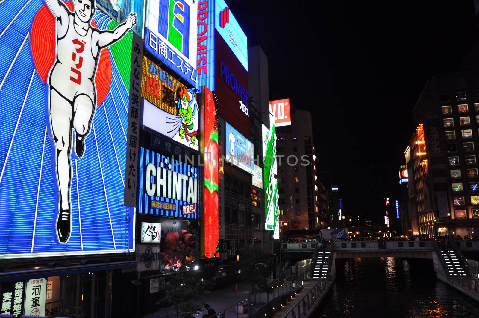 OSAKA, JAPAN - OCT 23: The Glico Man Running billboard and other neon displays on October 23, 2010 in Dotonbori, Osaka, Japan. Dotonbori has many shops, restaurants and colorful billboards. 