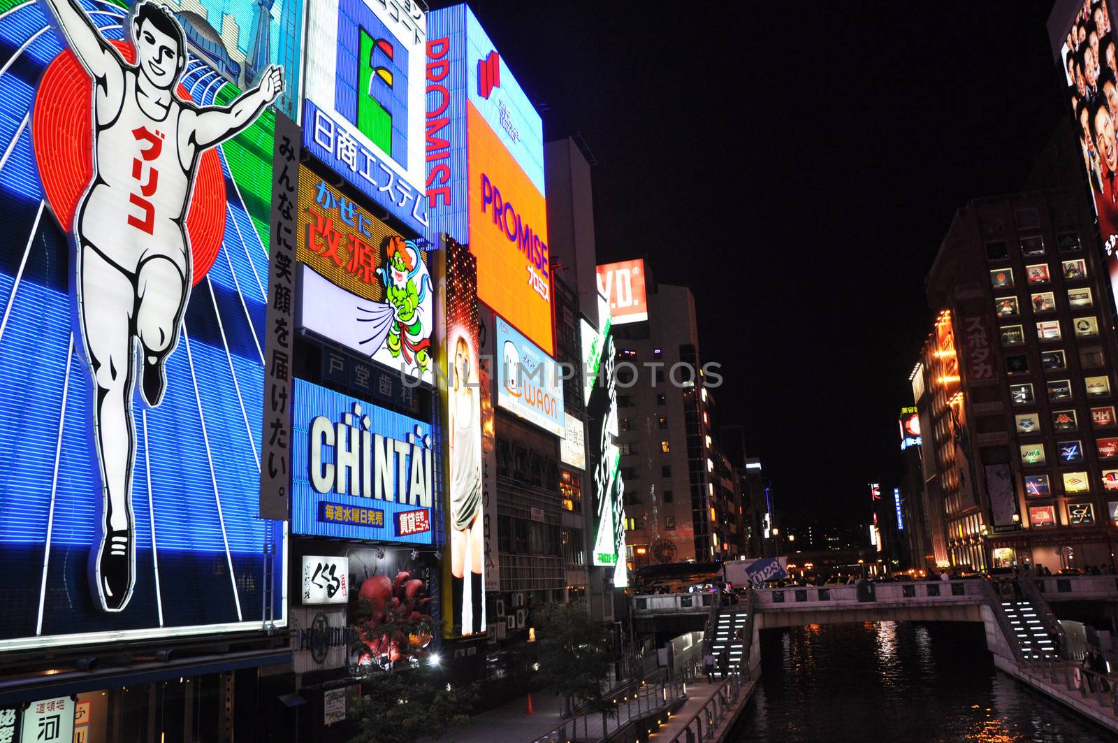 OSAKA, JAPAN - OCT 23: The Glico Man Running billboard and other neon displays on October 23, 2010 in Dotonbori, Osaka, Japan. Dotonbori has many shops, restaurants and colorful billboards. 