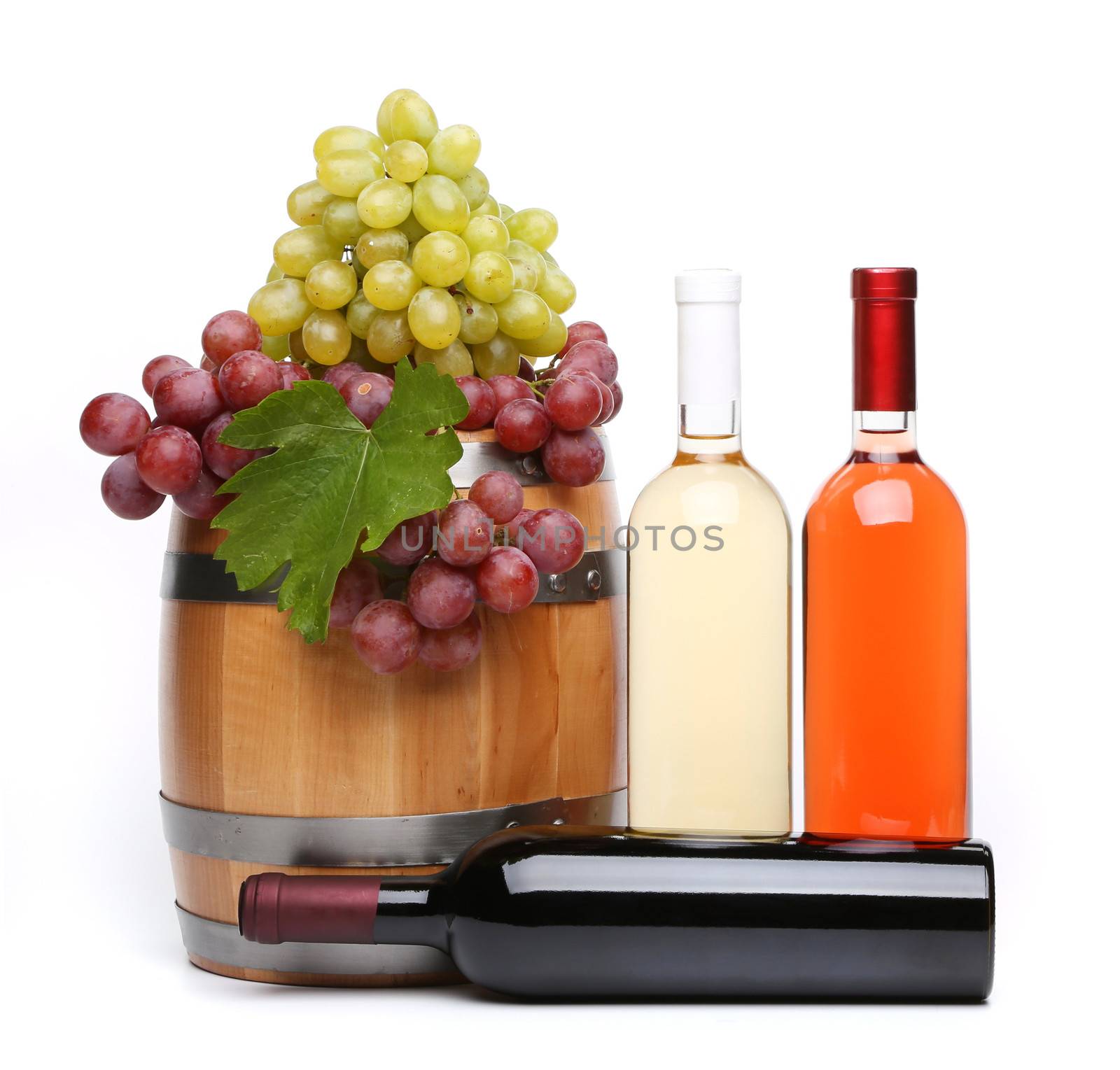 barrel and bottles of wine and ripe grapes on barrel