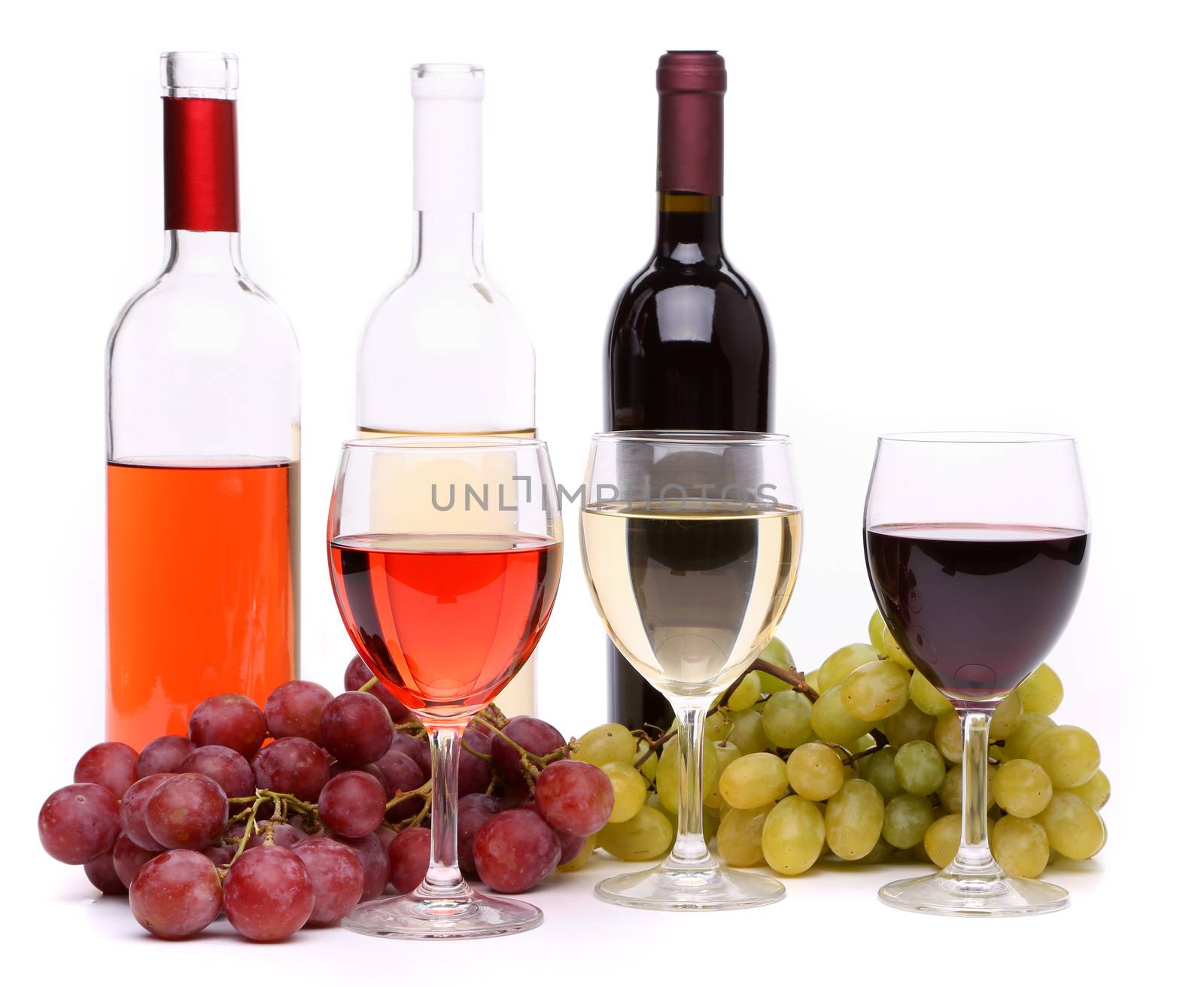 Ripe grapes, wine glasses and bottles of wine isolated on white