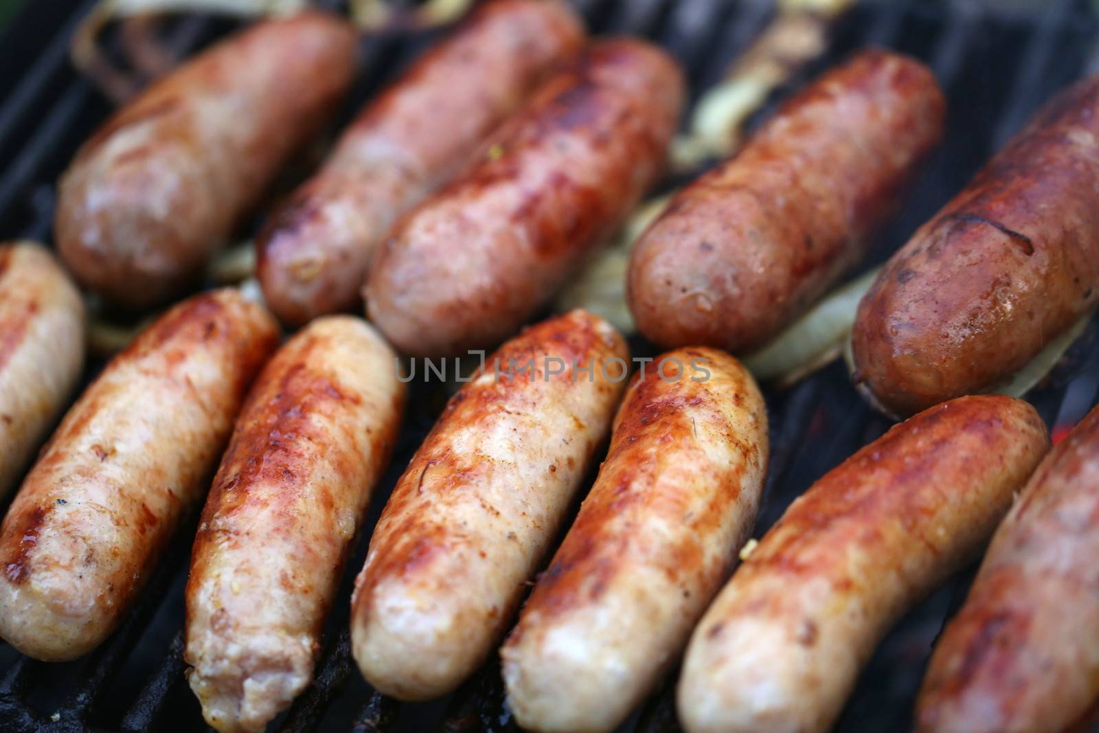 A lot of grilled sausages close up, barbecue by indigolotos
