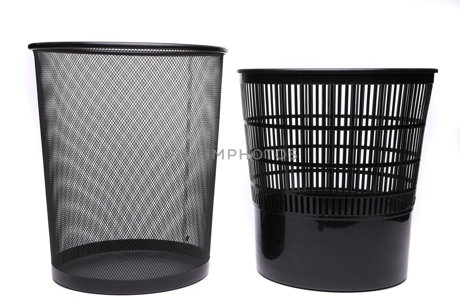 Metal and plastic trash cans on white background by indigolotos