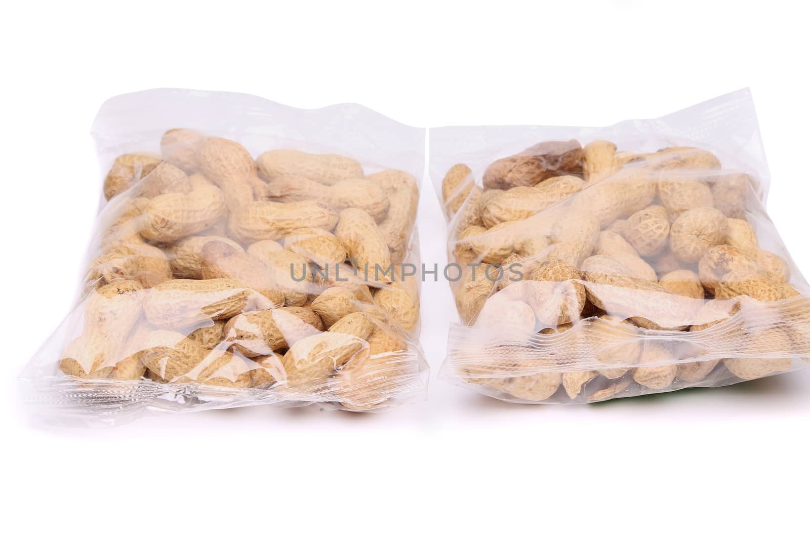 Two large plastic bags of peanuts by indigolotos