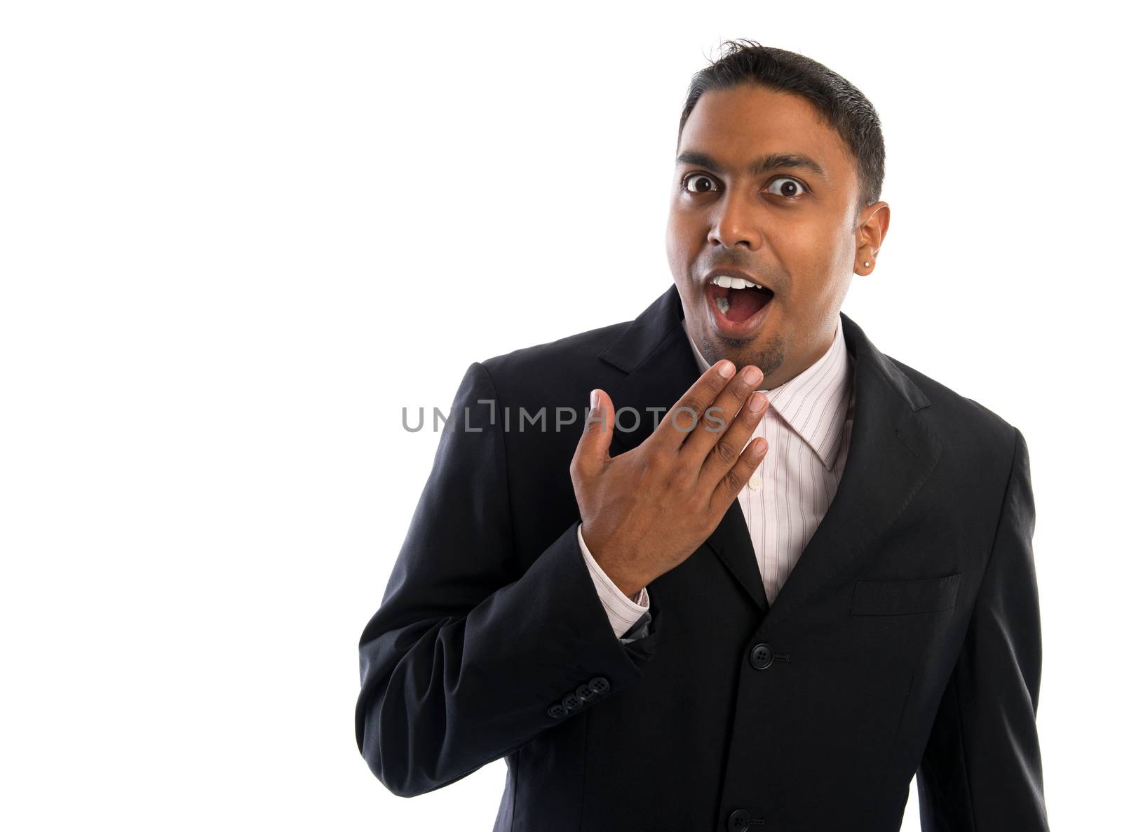 Indian businessman surprise. Good looking Indian man in black suit showing surprising face, isolated on white background.