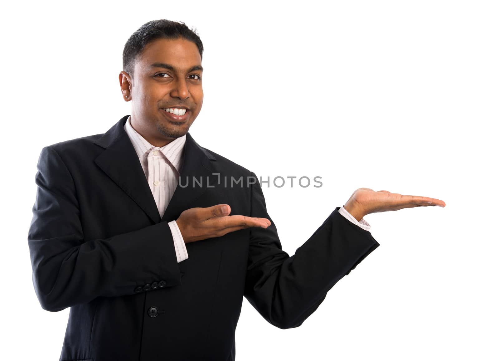 Indian businessman showing blank space. Young Indian man displaying empty copyspace, isolated on white background.  