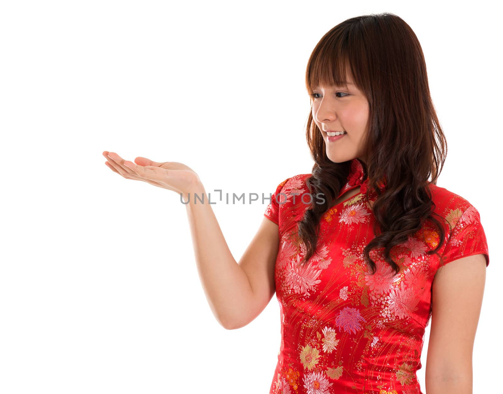 Chinese Cheongsam woman showing empty palm isolated on white background.