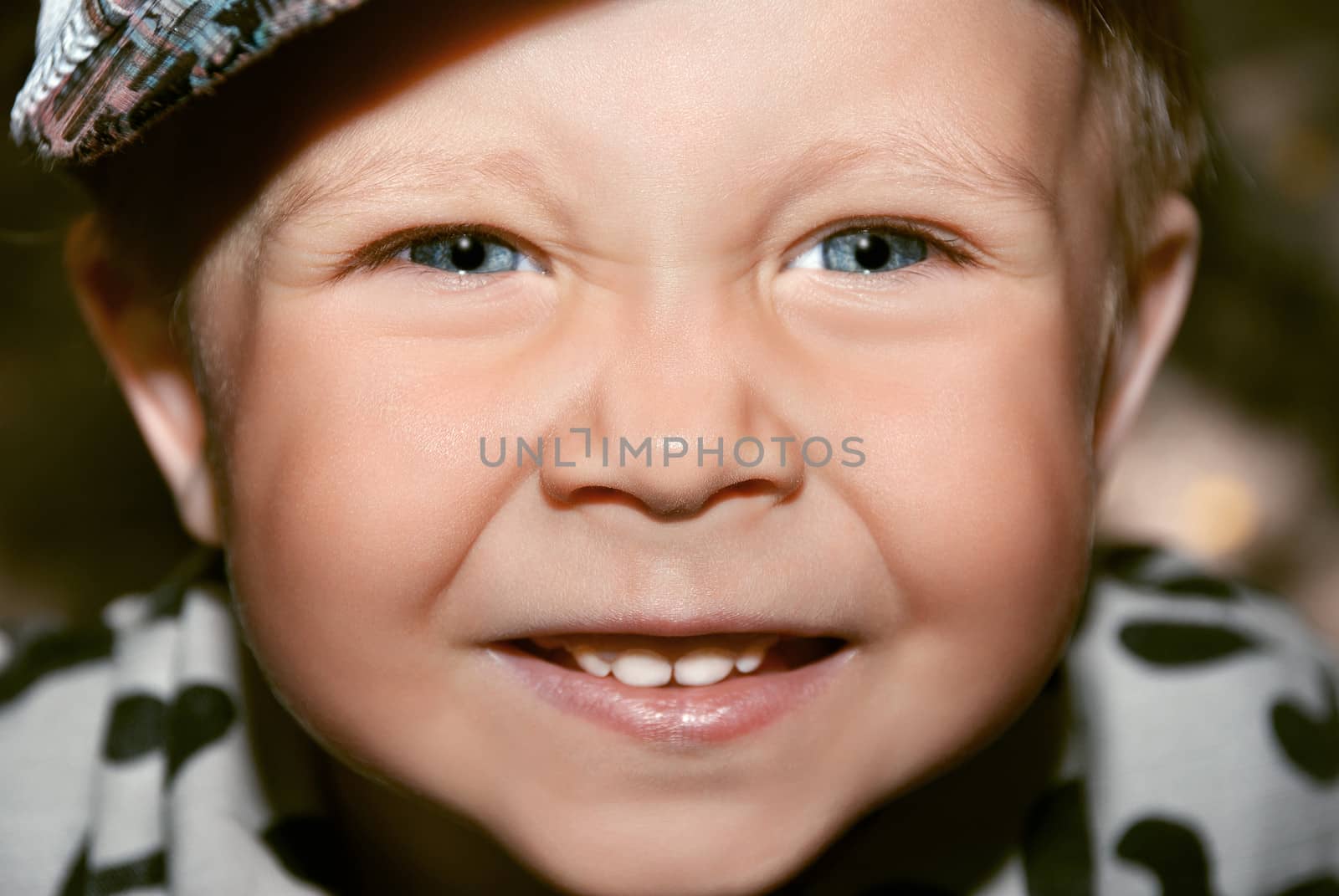 Beautiful and cheerful boy. Close-up portrait.