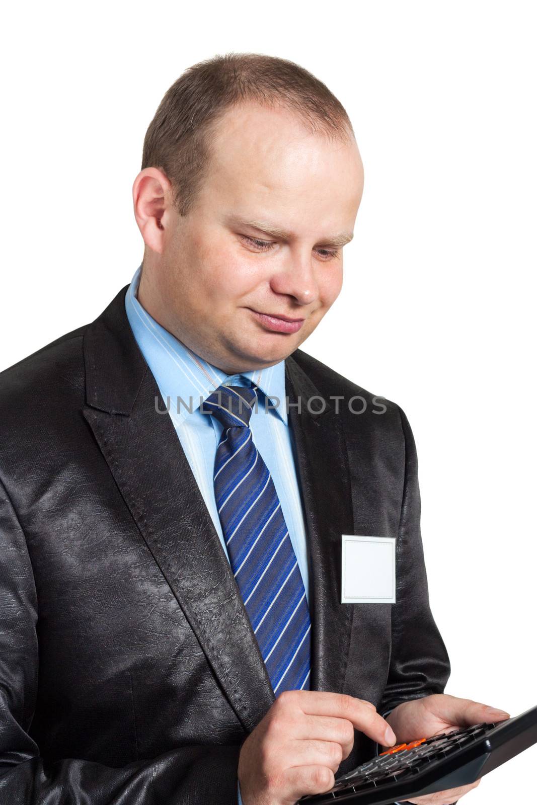 Businessman counting his profits on a calculator isolated