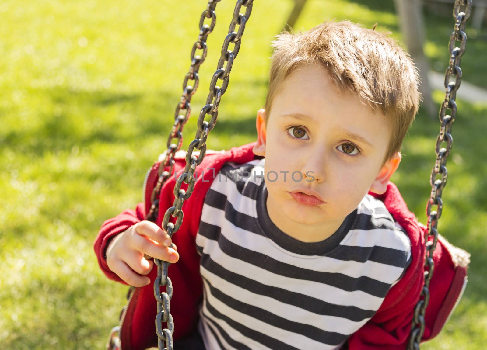 A child playing at the playground on a sunny day.
