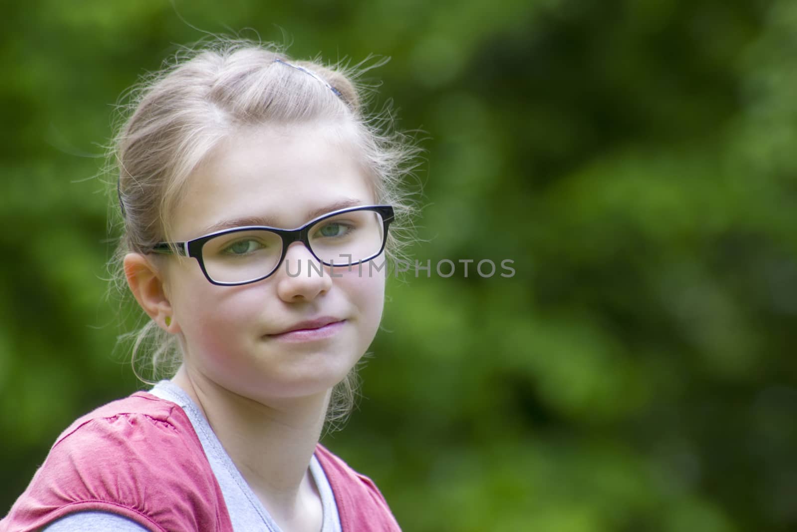 Young girl in park in spring day - portrait