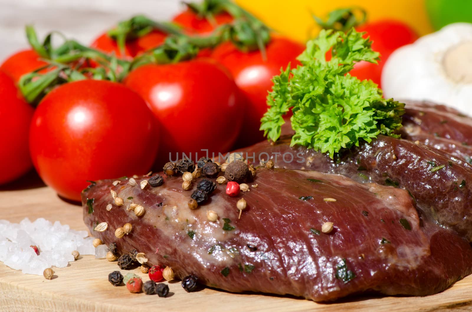 meat with fresh vegetables on wooden board