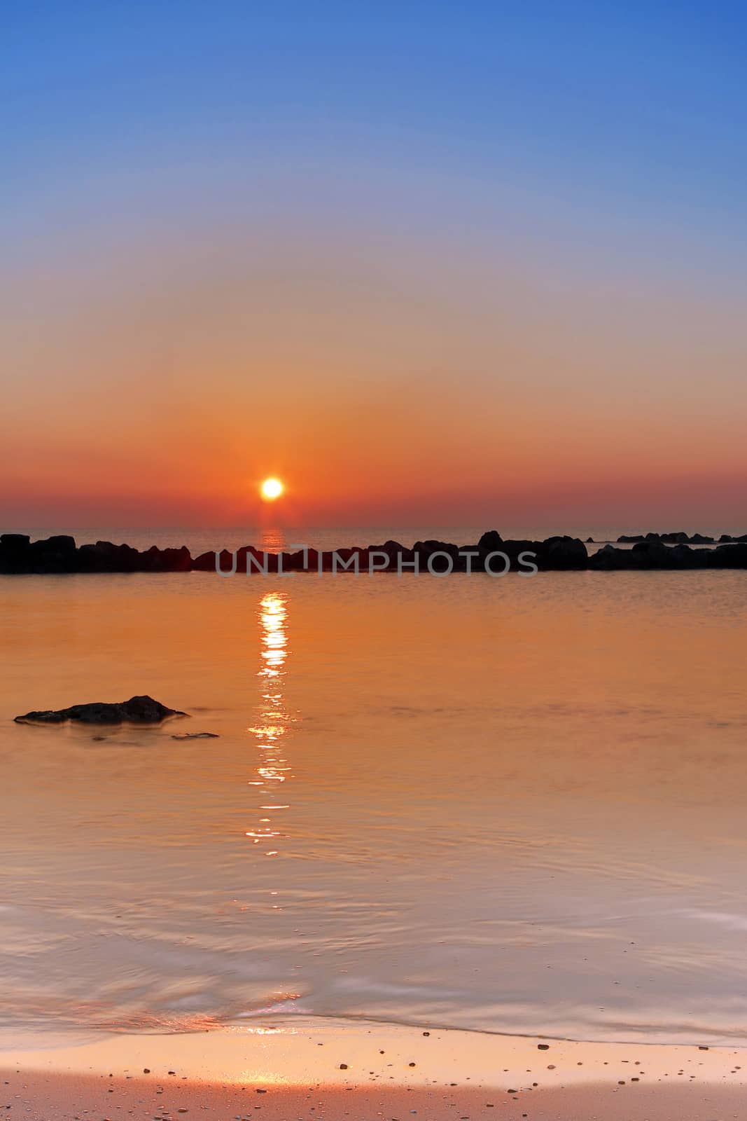 Sunrise over the Adriatic Sea, Italy.
The rising sun touches the rocks and creates a nice reflection on the water.