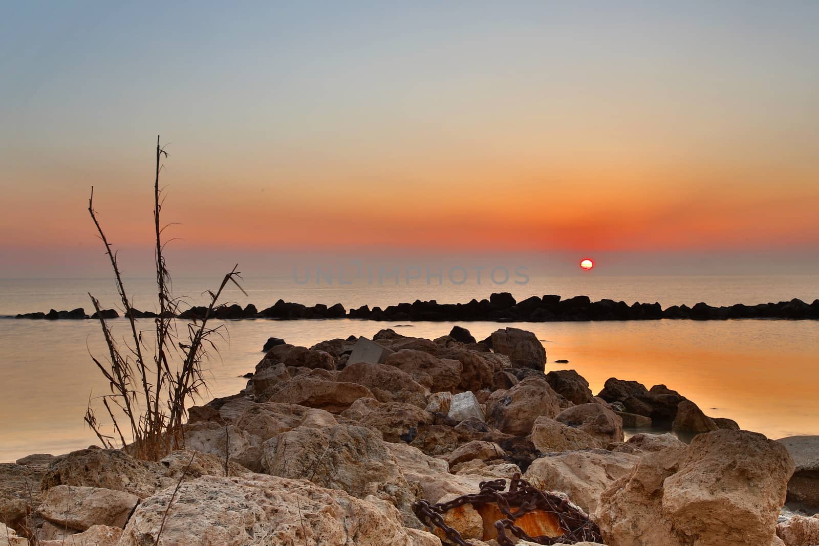 Sunrise over the Adriatic Sea, Italy.
The rising sun touches the rocks and creates a nice reflection on the water.