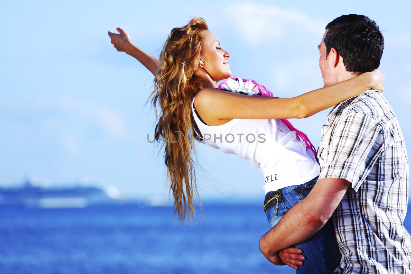 man and woman hug in the sky and sea on sea