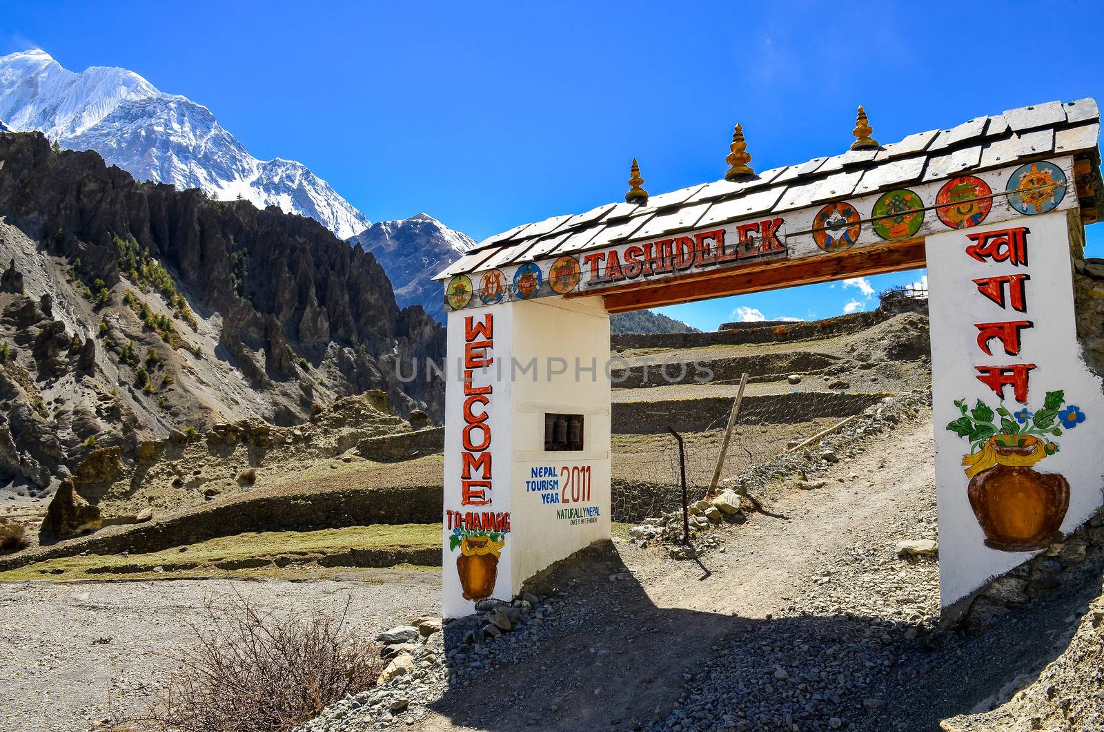 Entrance gate with welcome sign, Manang, Nepal by martinm303